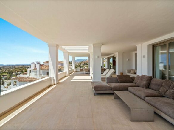 Covered terrace with lounge seating and sea views