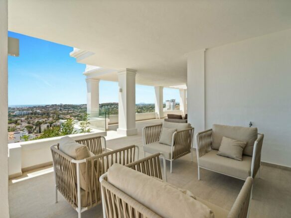 Covered terrace with seating and panoramic views