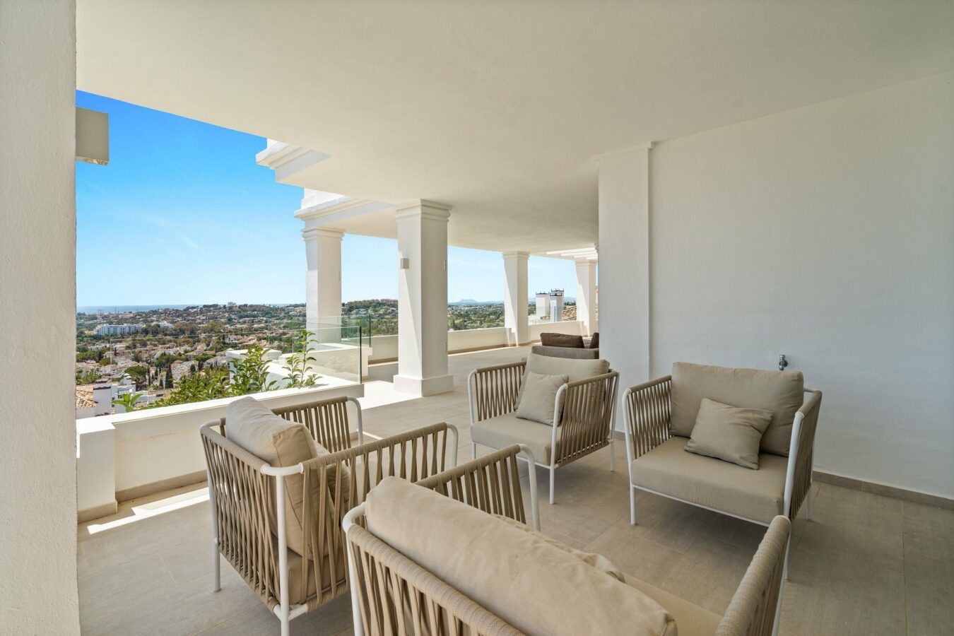 Covered terrace with seating and panoramic views