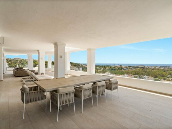 Covered terrace dining area with sea views