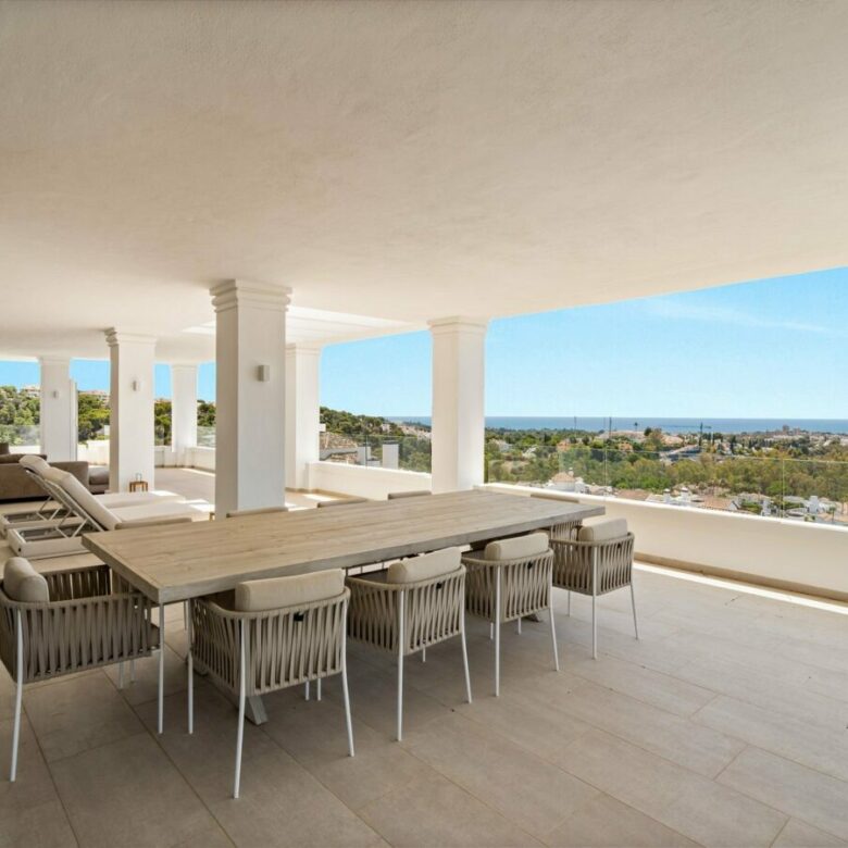Covered terrace dining area with sea views