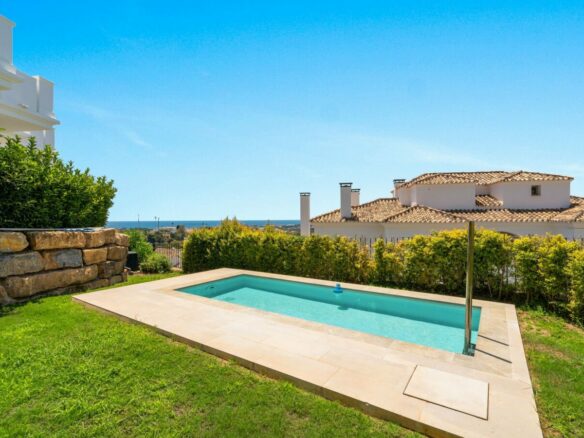 Swimming pool with lawn and sea views