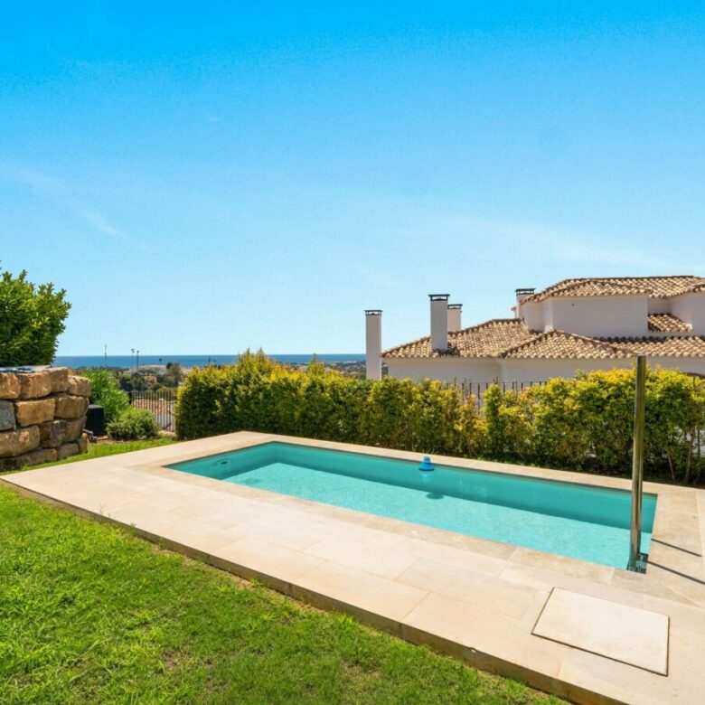 Swimming pool with lawn and sea views