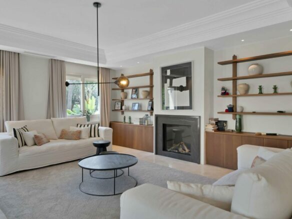 Living room with fireplace in the refurbished Lorea Playa villa, Puerto Banús