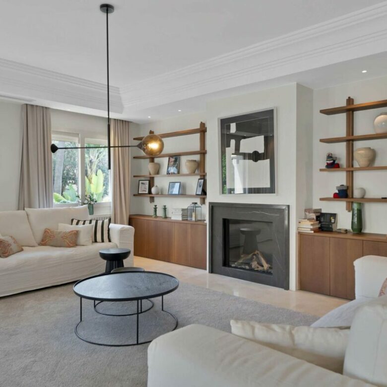 Living room with fireplace in the refurbished Lorea Playa villa, Puerto Banús