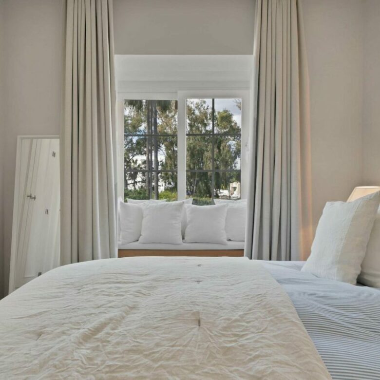 Guest bedroom with window seat in the beachside villa, Lorea Playa